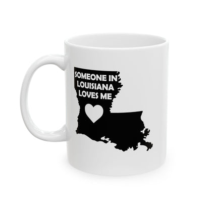 White mug with black silhouette of Louisiana and text 'Someone in Louisiana loves me' on a white background