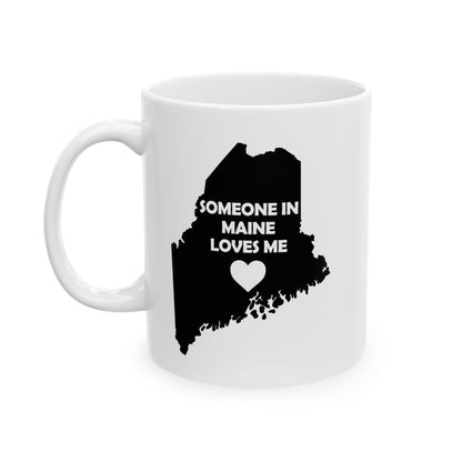 White mug with black silhouette of Maine and text 'Someone in Maine loves me' on a white background