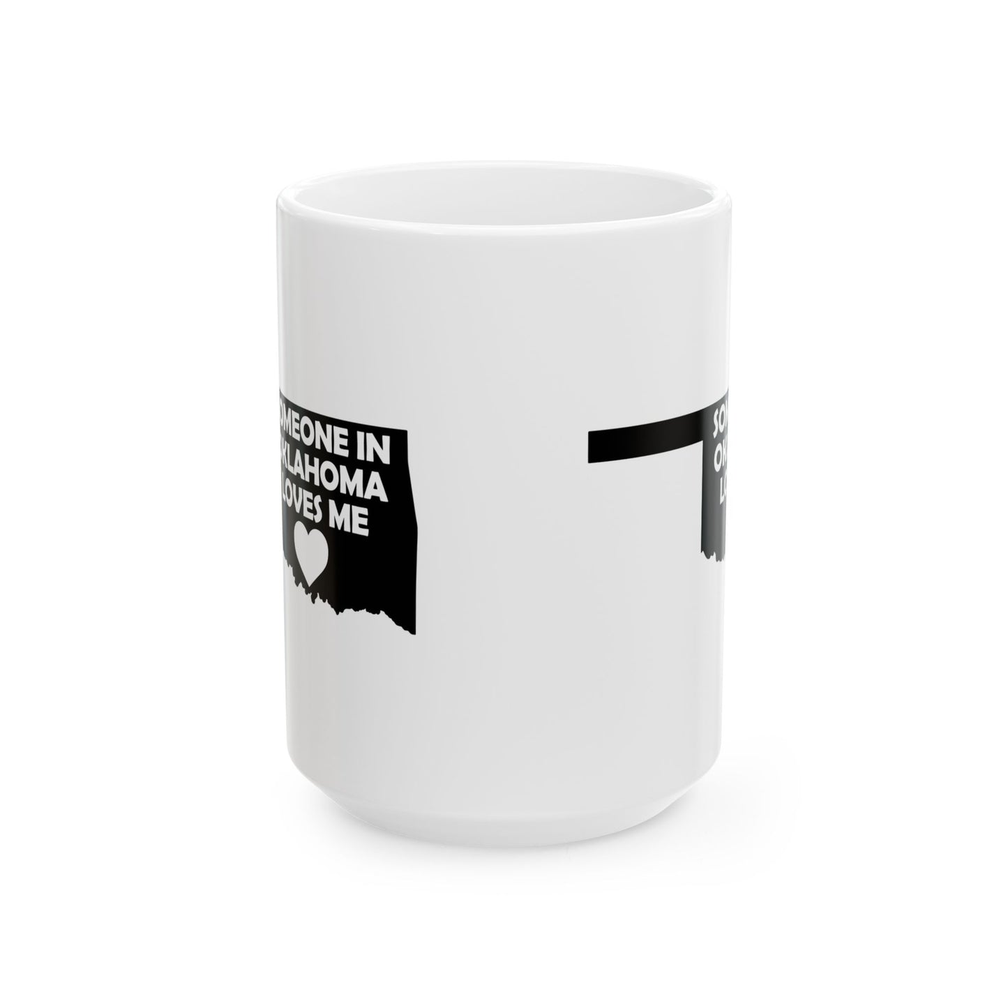 White mug with black text and heart design on a white background with text  Someone In Oklahoma Loves Me