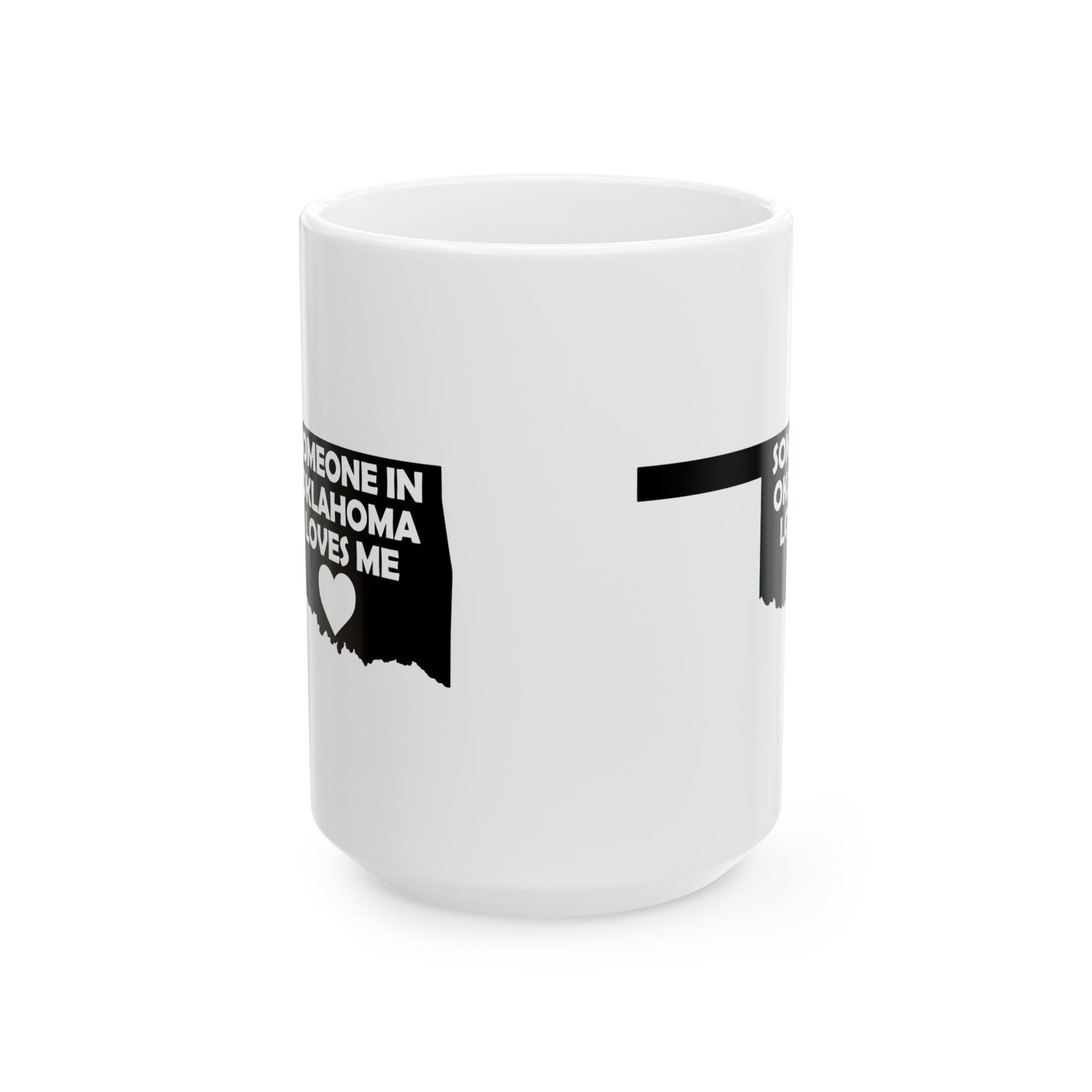 White mug with black text and heart design on a white background with text  Someone In Oklahoma Loves Me
