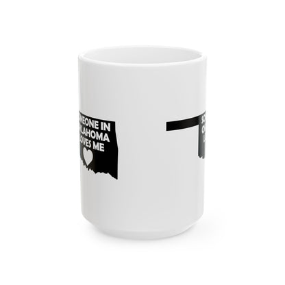 White mug with black text and heart design on a white background with text  Someone In Oklahoma Loves Me