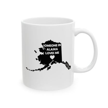 White mug with black map of Alaska and text 'Someone in Alaska loves me' on a white background