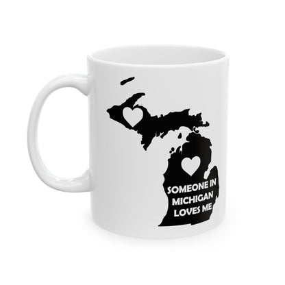 White mug with black outline of Michigan and text 'Someone in Michigan loves me' on a white background