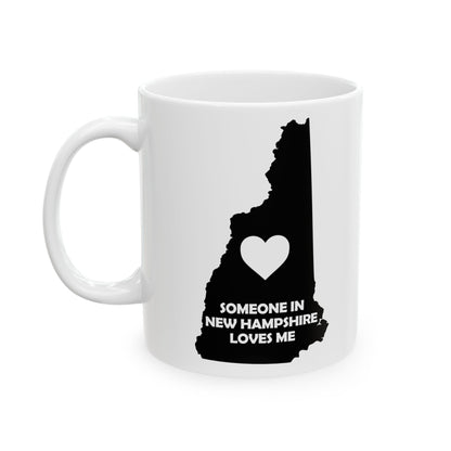 White mug with black silhouette of New Hampshire and heart design on a white background