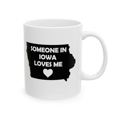 White mug with black Iowa outline and text 'Someone in Iowa loves me' on a white background