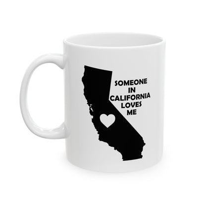 White mug with black silhouette of California and text 'Someone in California loves me' on a white background