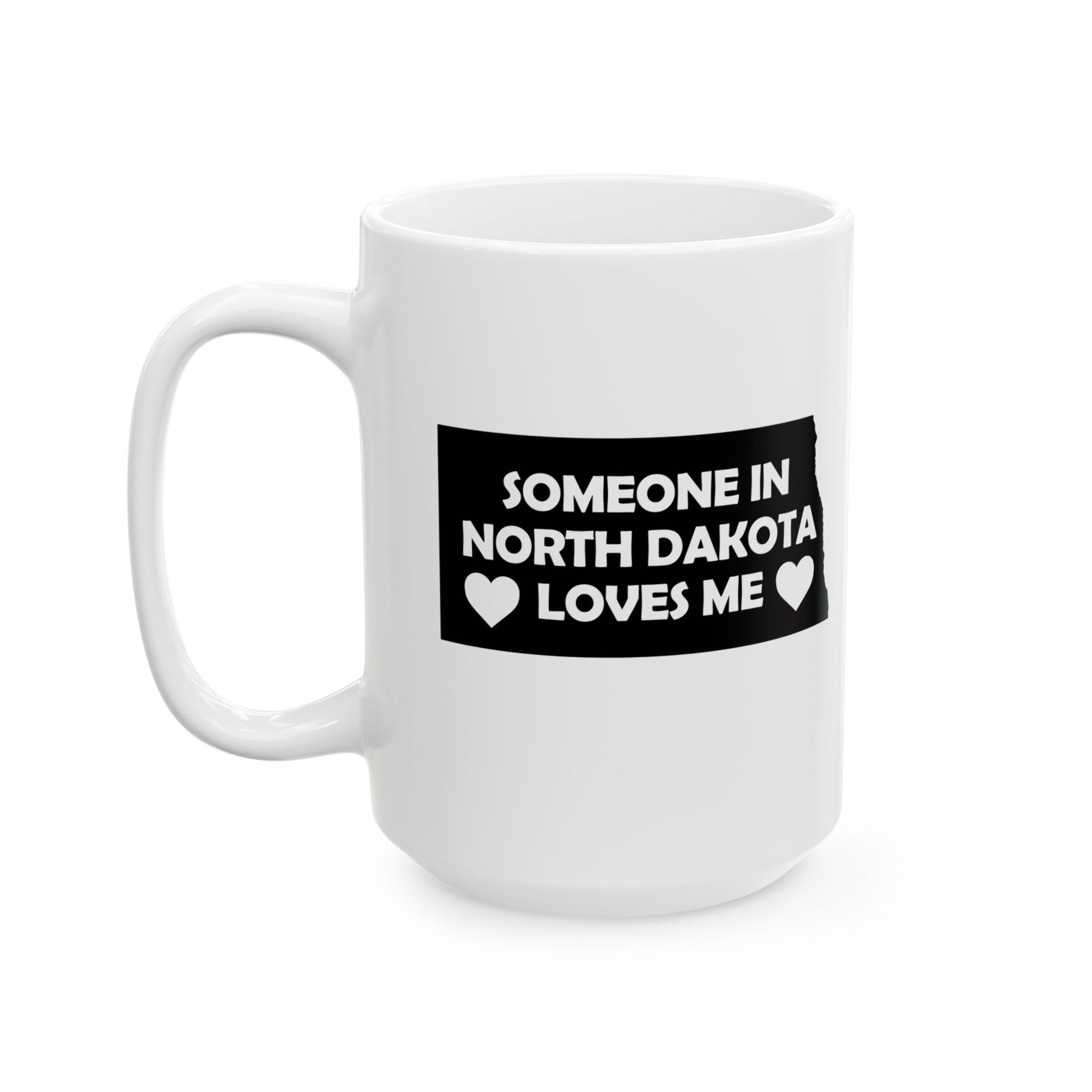 White mug with a black label reading 'Someone in North Dakota loves me' on a white background