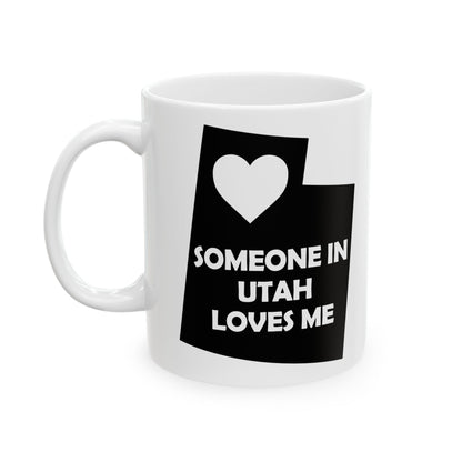 White mug with black graphic and text 'SOMEONE IN UTAH LOVES ME' on a white background