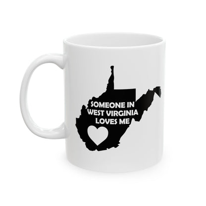 White mug with black silhouette of West Virginia and text 'Someone in West Virginia loves me' on a white background