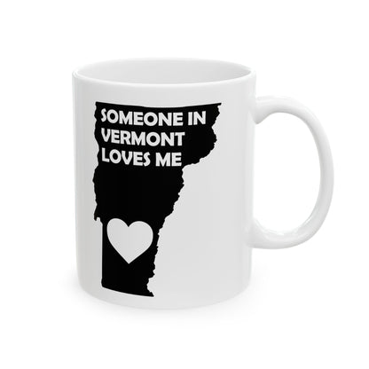 White mug with black silhouette of Vermont and text 'Someone in Vermont loves me' on a white background