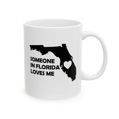 White mug with black silhouette of Florida and text 'Someone in Florida loves me' on a white background