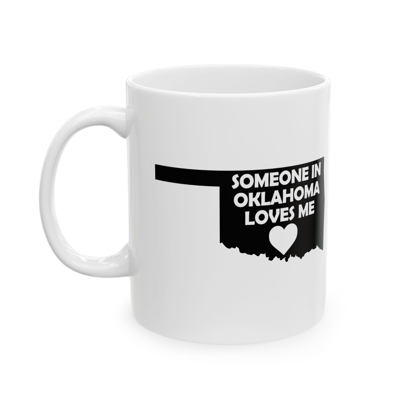 White mug with black text and heart design on a white background with text  Someone In Oklahoma Loves Me