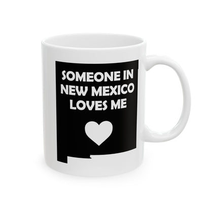 White mug with black design featuring text and a heart on a white background with text  Someone In New Mexico Loves Me