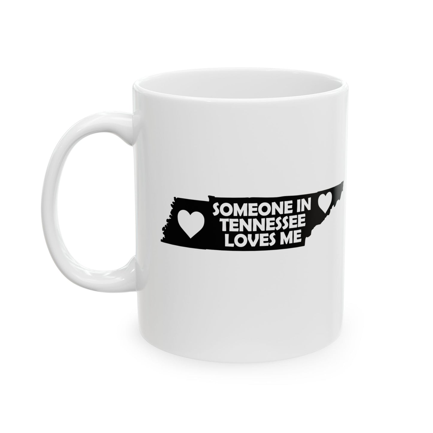 White mug with black text and heart design on a white background  with text  Someone In Tennessee Loves Me