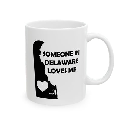 White mug with black silhouette of Delaware and text 'Someone in Delaware loves me' on a white background