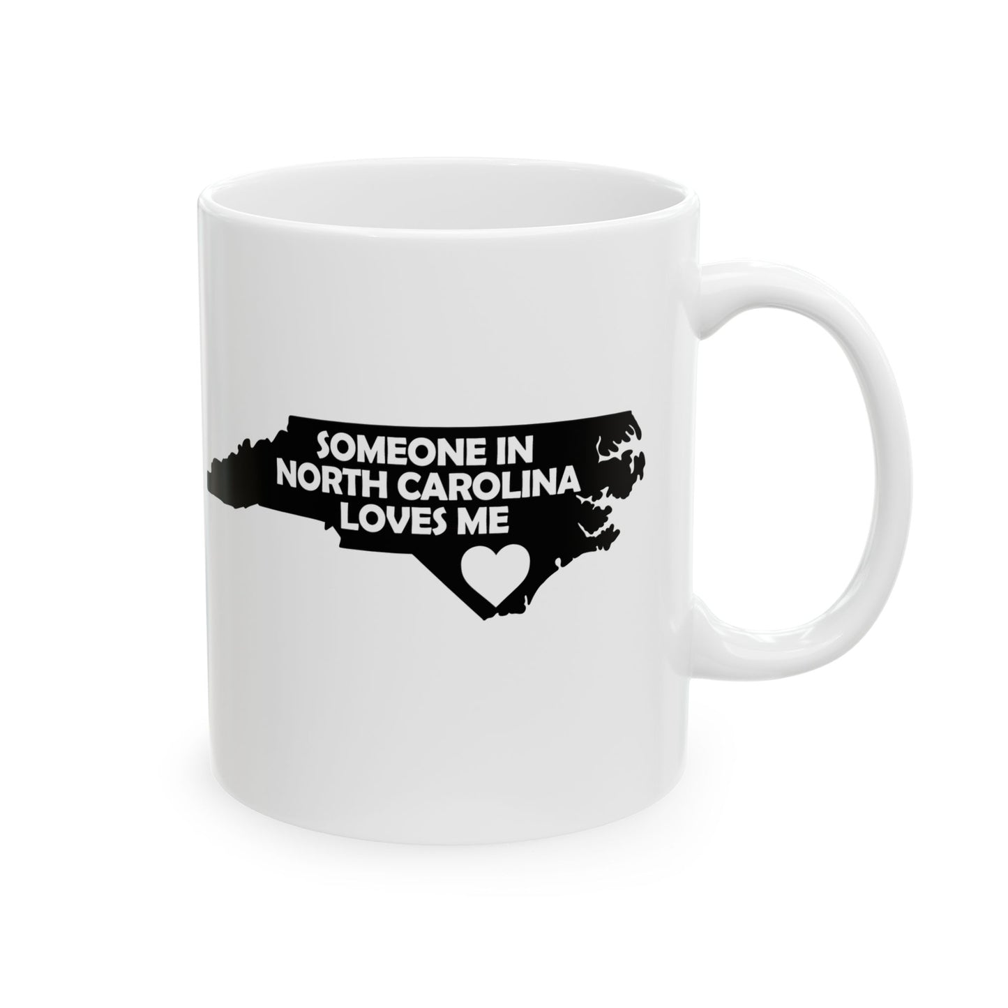 White mug with black text and map of North Carolina on a white background with text  Someone In North Carolina Loves Me