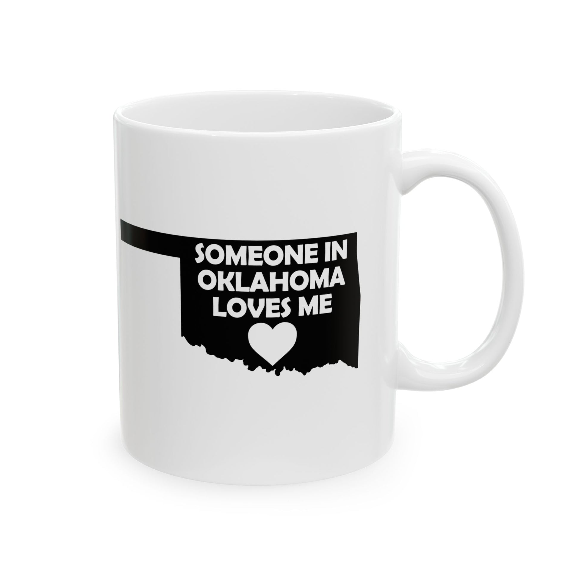 White mug with black text and heart design on a white background  with text  Someone In Oklahoma Loves Me