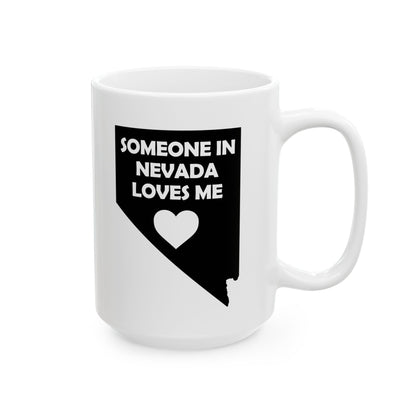 White mug with black text and heart design on a white background with text  Someone In Nevada Loves Me
