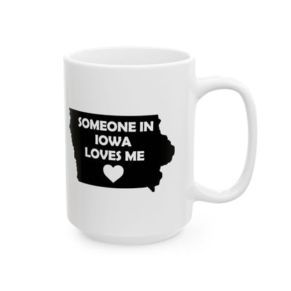 White mug with black text 'SOMEONE IN IOWA LOVES ME' and a heart on a white background