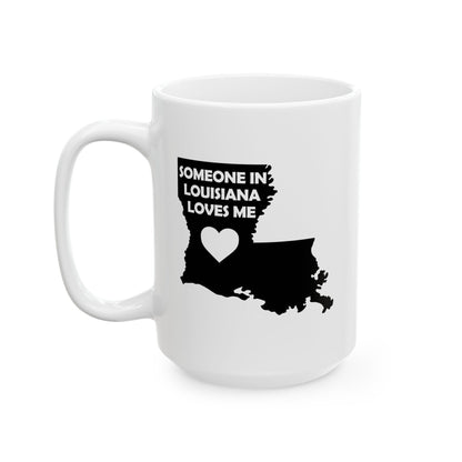 White mug with black silhouette of Louisiana and text 'Someone in Louisiana loves me' on a white background