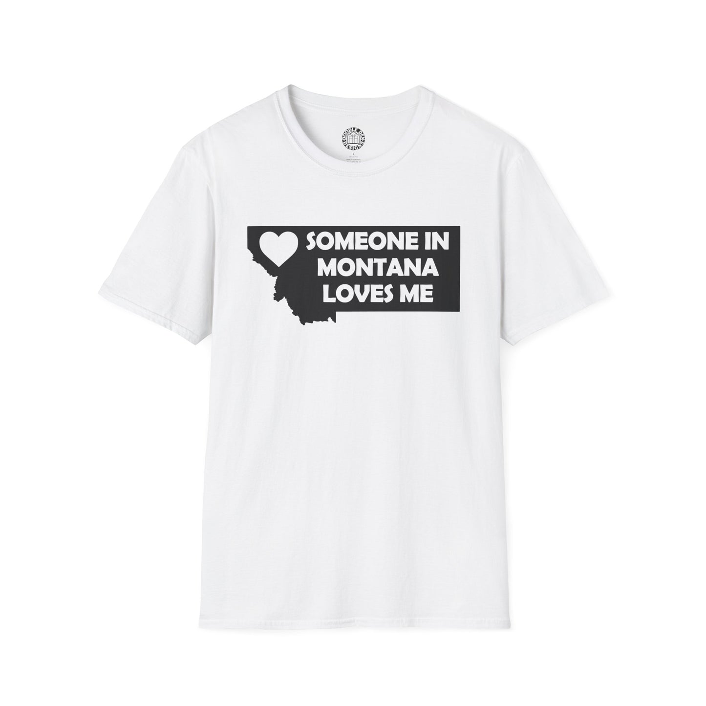 White t-shirt with black text 'SOMEONE IN MONTANA LOVES ME' on a white background