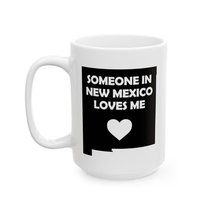 White mug with black design featuring text and a heart on a white background with text  Someone In New Mexico Loves Me