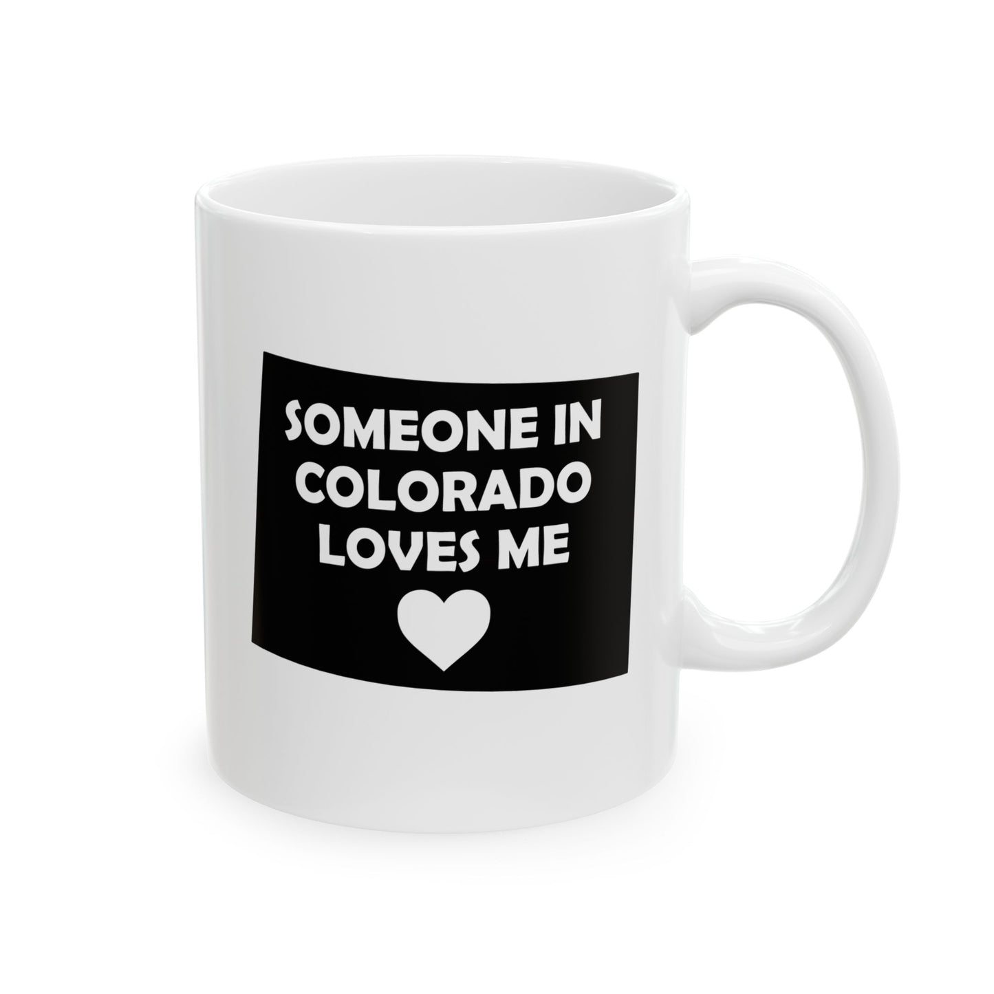 White mug with black label text 'SOMEONE IN COLORADO LOVES ME' and a heart symbol on a white background