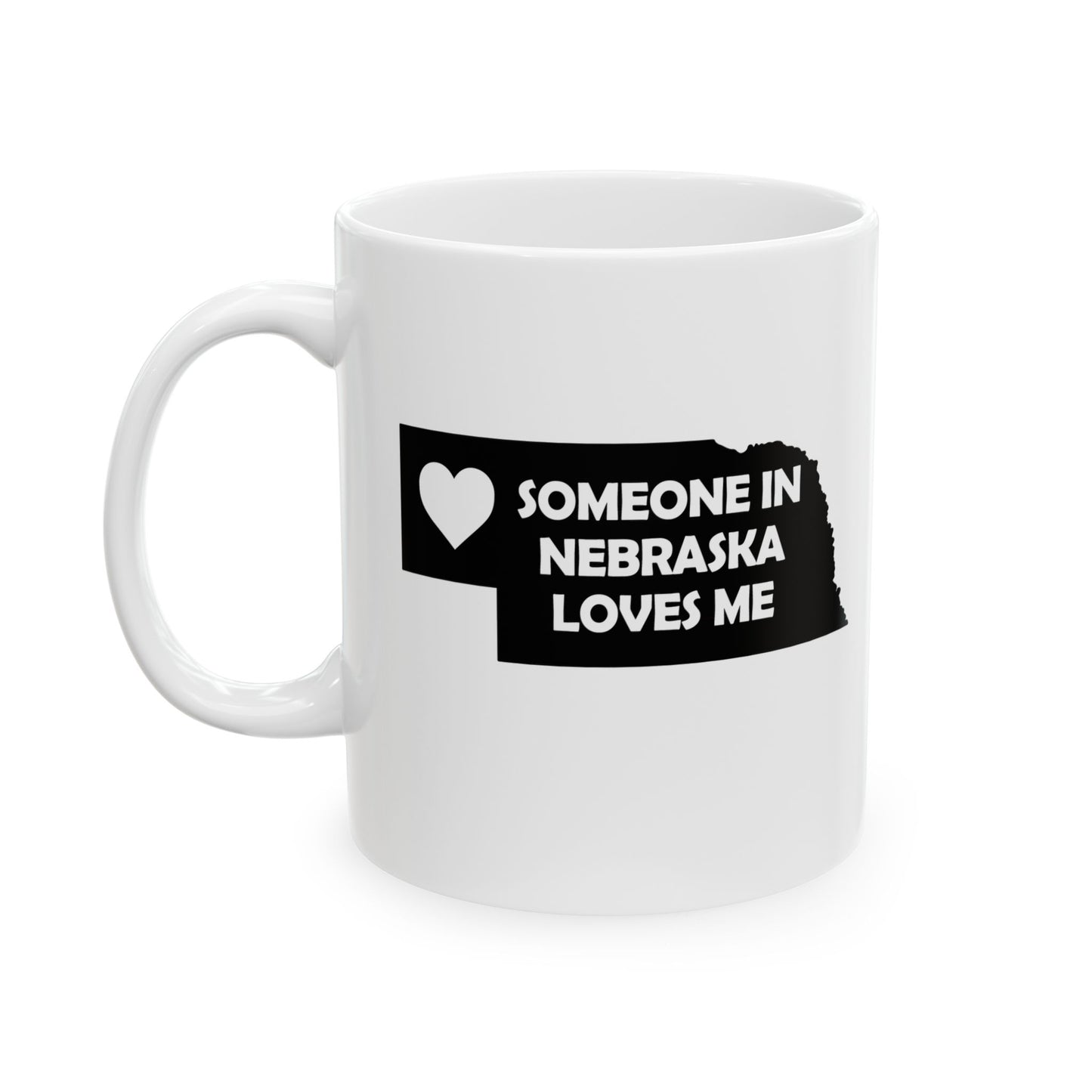 White mug with black text and heart design on a white background with text  Someone In Nebraska Loves Me