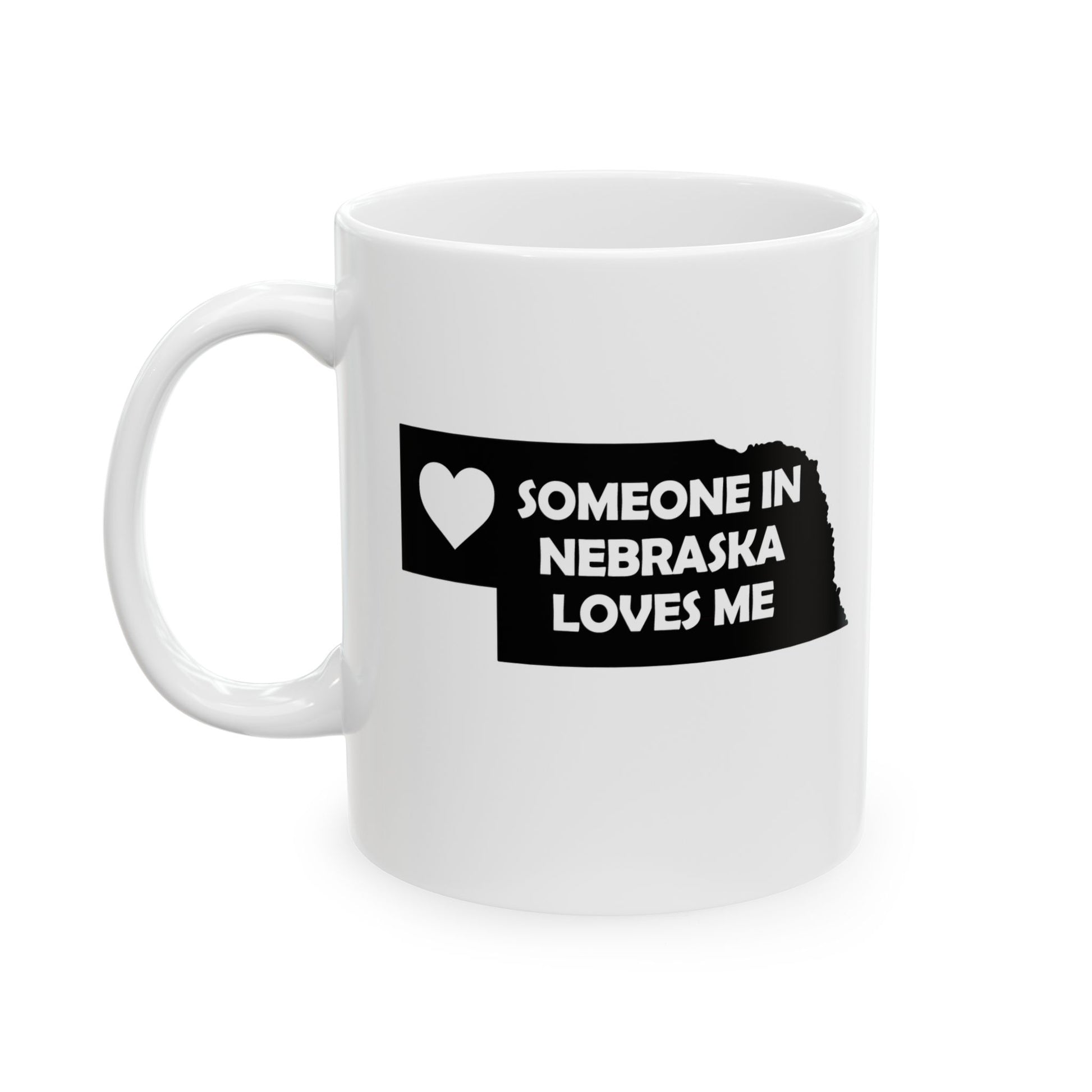 White mug with black text and heart design on a white background with text  Someone In Nebraska Loves Me