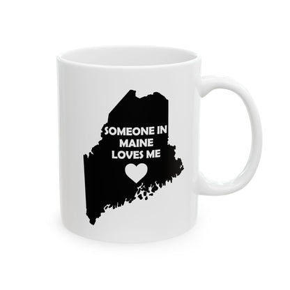 White mug with black silhouette of Maine and text 'Someone in Maine loves me' on a white background