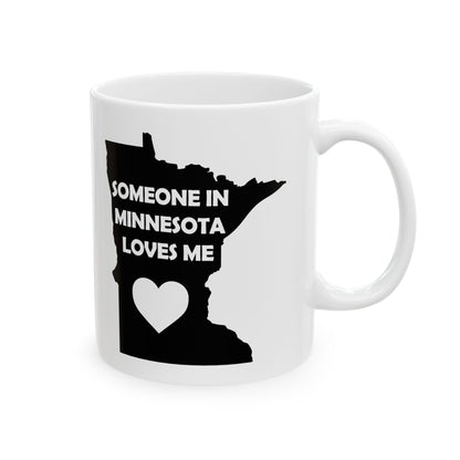 White mug with black silhouette of Minnesota and text 'Someone in Minnesota loves me' on a white background