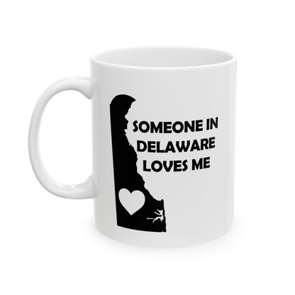 White mug with black silhouette of Delaware and text 'Someone in Delaware loves me' on a white background