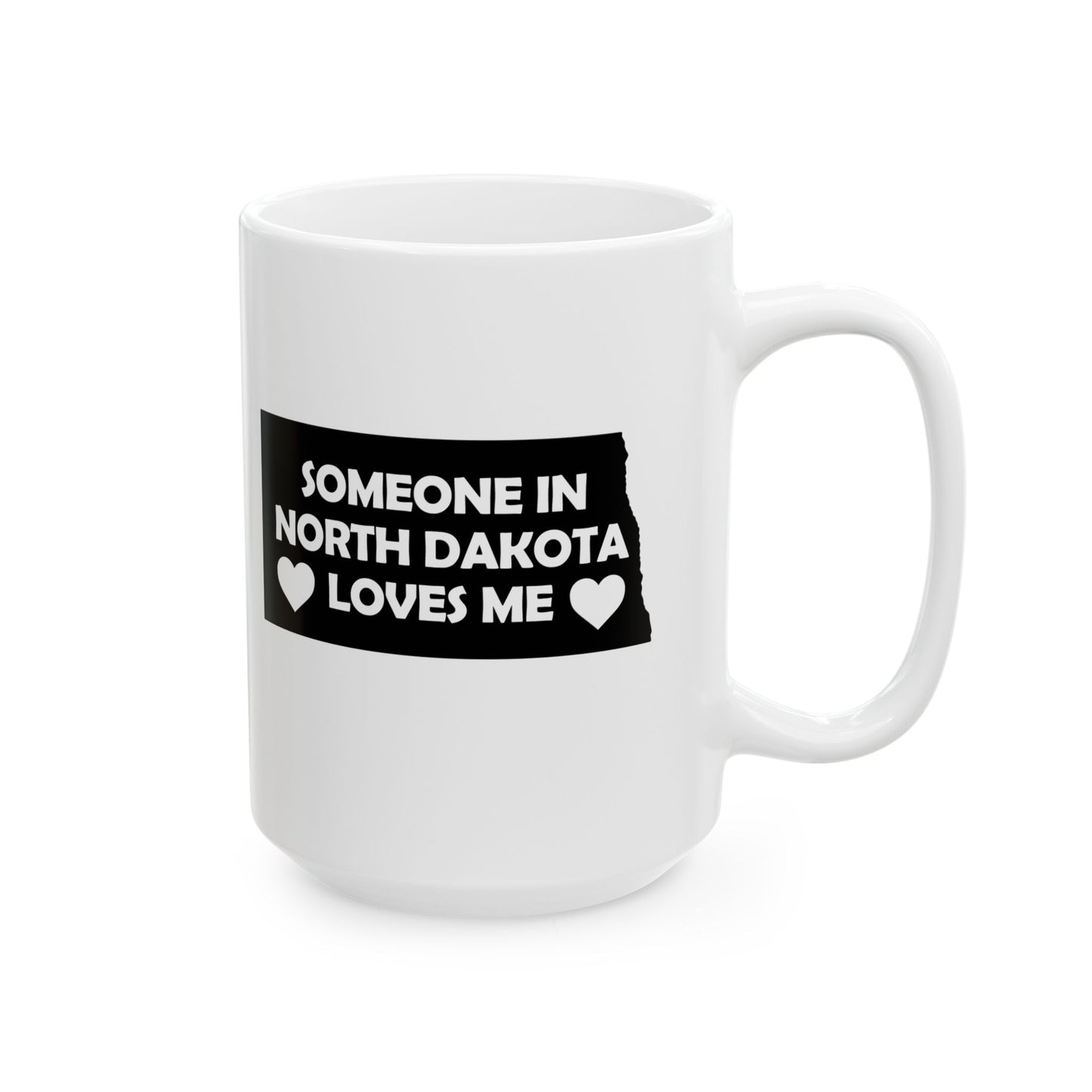 White mug with a black label reading 'Someone in North Dakota loves me' on a white background