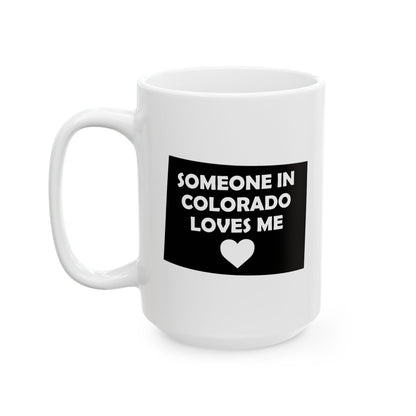 White mug with a black label reading 'Someone in Colorado loves me' on a white background