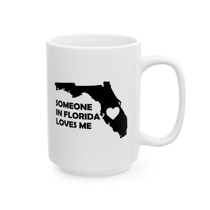 White mug with black state of Florida outline and text 'Someone in Florida loves me' on a white background