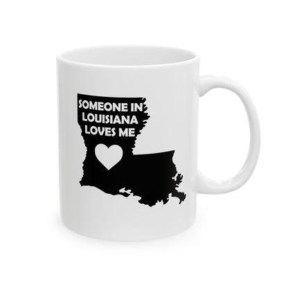 White mug with black silhouette of Louisiana and text 'Someone in Louisiana loves me' on a white background