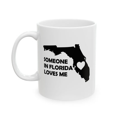 White mug with black silhouette of Florida and text 'Someone in Florida loves me' on a white background