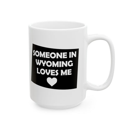 White mug with black label text 'SOMEONE IN WYOMING LOVES ME' and a heart symbol on a white background
