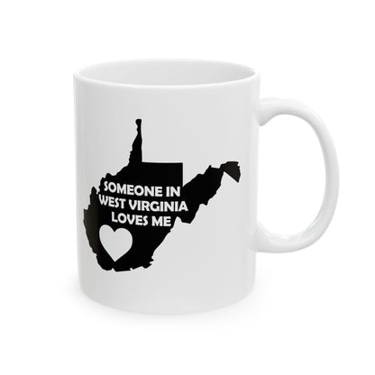 White mug with black silhouette of West Virginia and text 'Someone in West Virginia loves me' on a white background