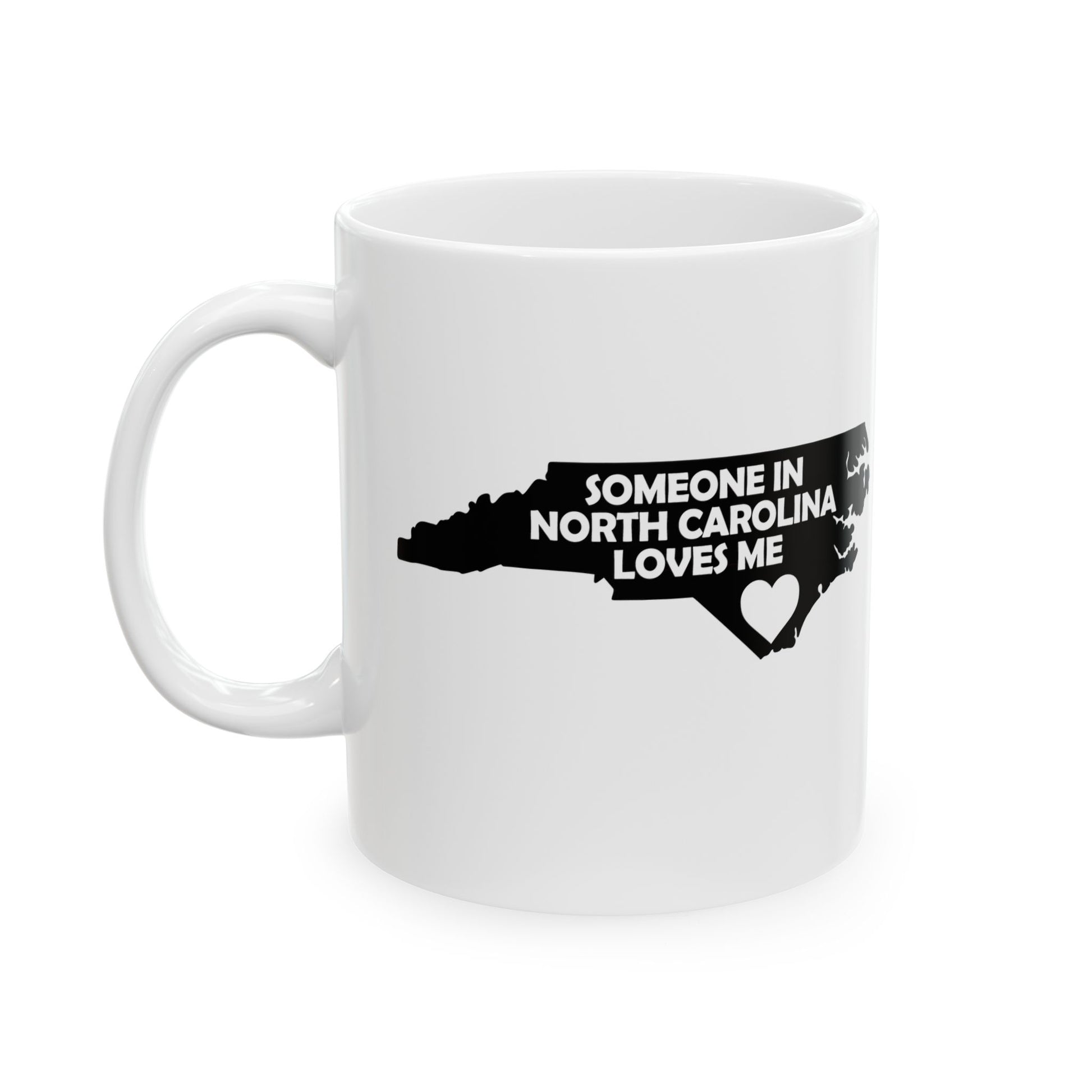 White mug with black text and map of North Carolina on a white background with text  Someone In North Carolina Loves Me