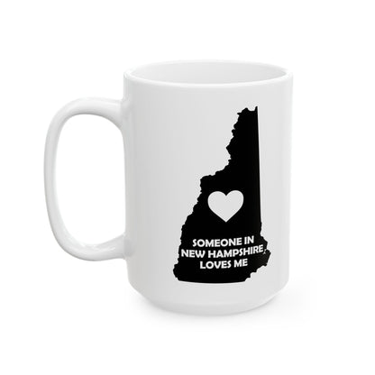 White mug with black silhouette of New Hampshire and heart design on a white background