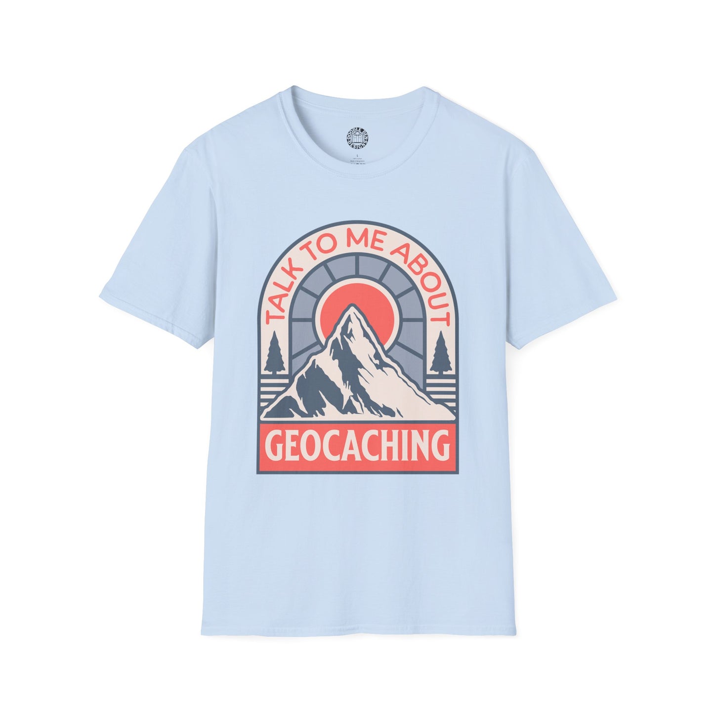 Light blue t-shirt with a mountain graphic and text 'Talk to me about geocaching' on a white background