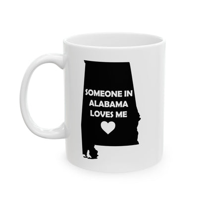 White mug with black silhouette of Alabama and text 'Someone in Alabama loves me' on a white background