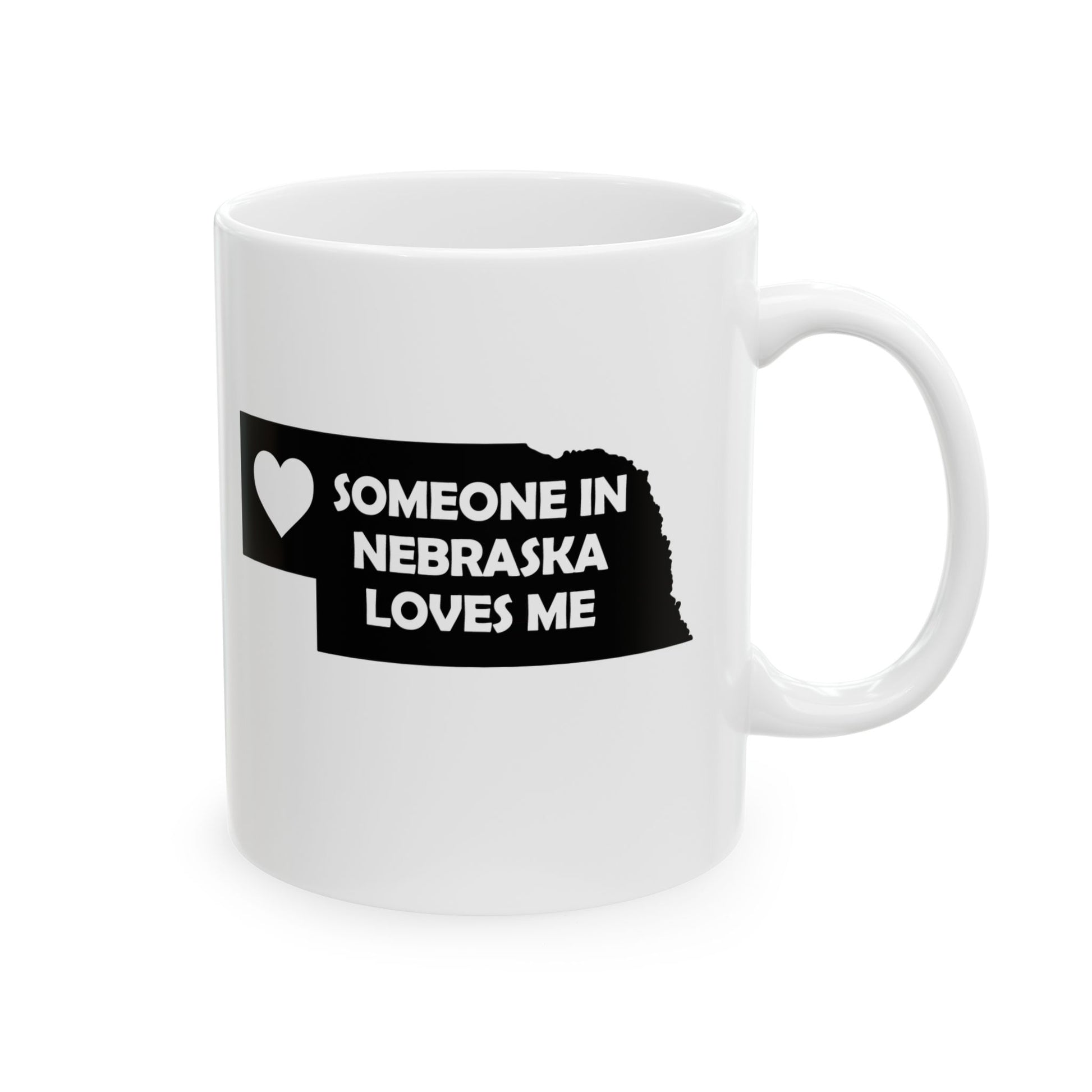 White mug with a black design featuring 'Someone in Nebraska Loves Me' text on a white background