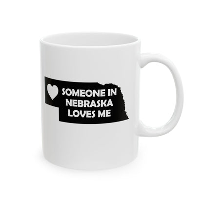 White mug with a black design featuring 'Someone in Nebraska Loves Me' text on a white background