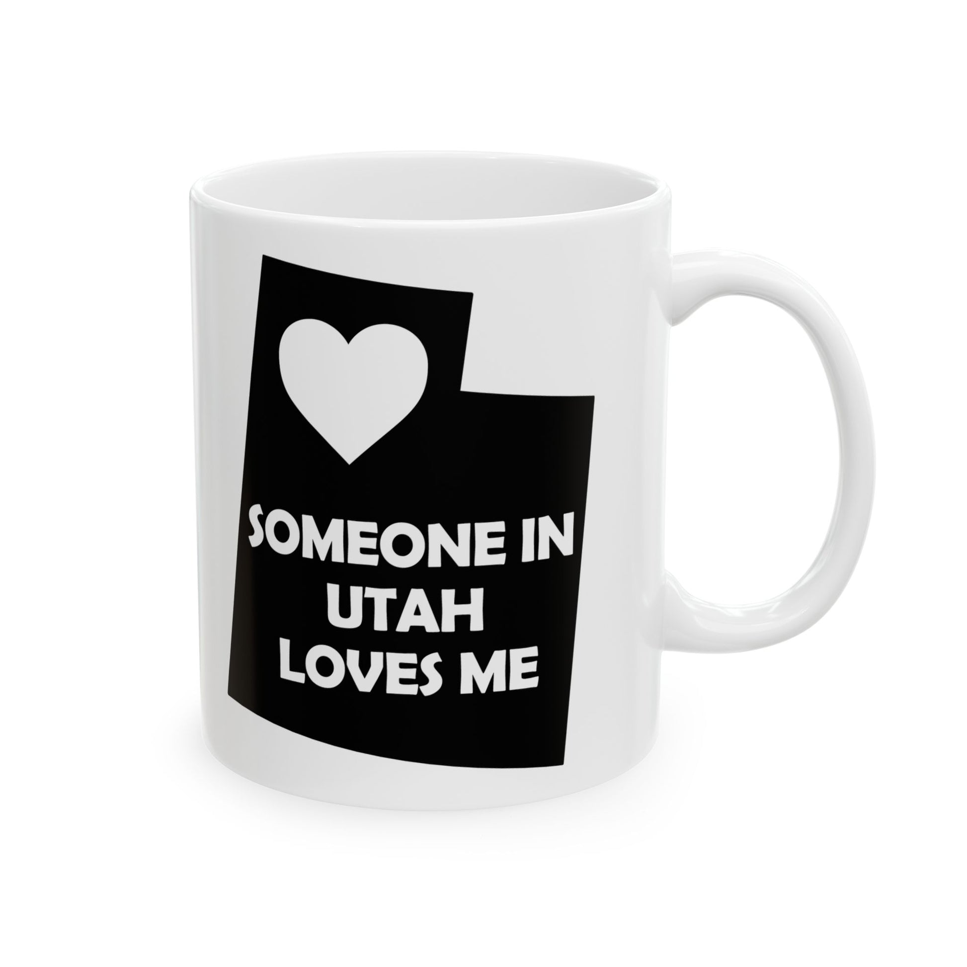 White mug with black design featuring a heart and text on a white background  with text  Someone In Utah Loves Me