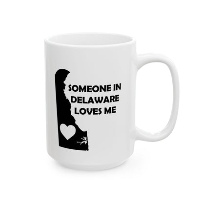 White mug with black silhouette of Delaware and text 'Someone in Delaware loves me' on a white background