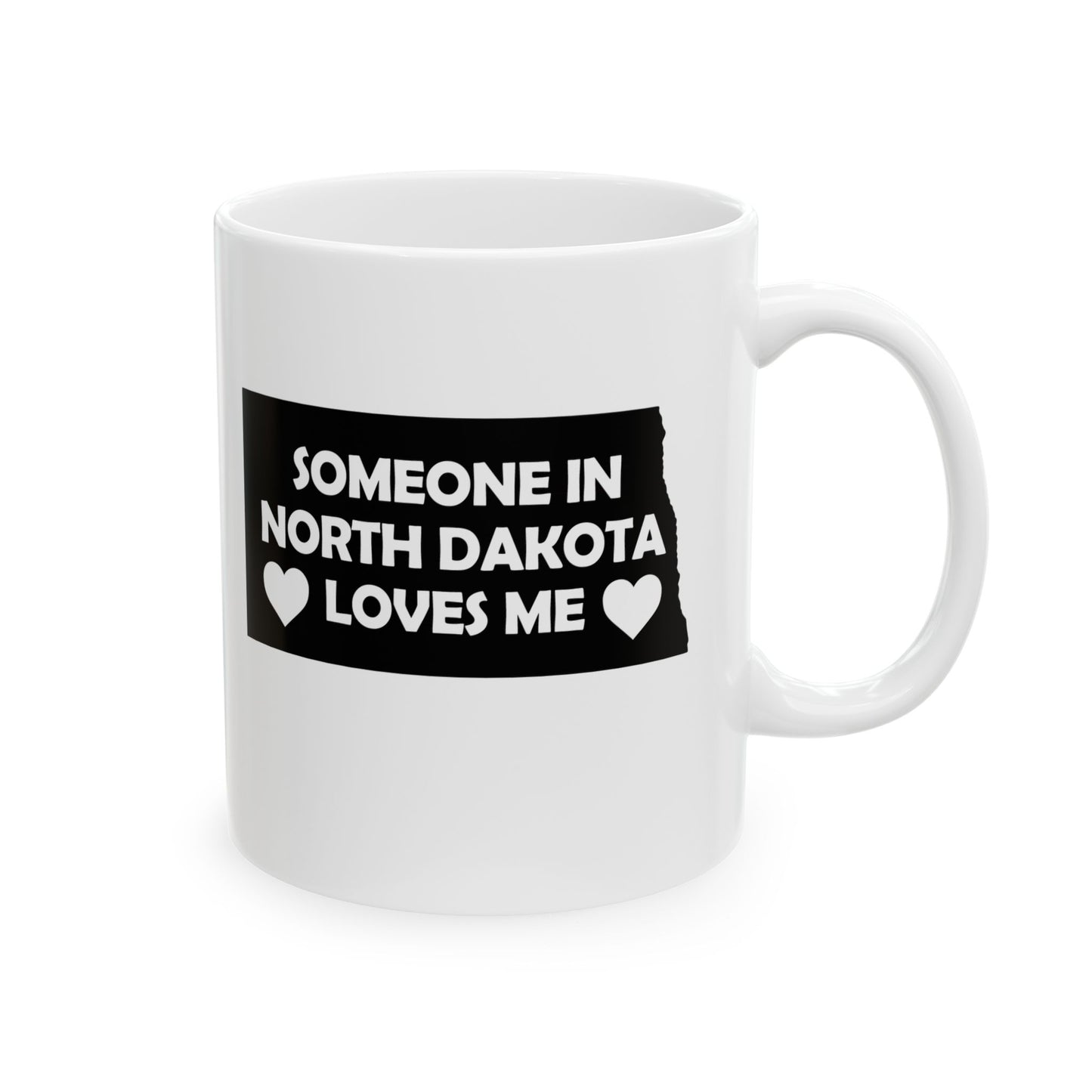 White mug with a black label reading 'Someone in North Dakota loves me' on a white background