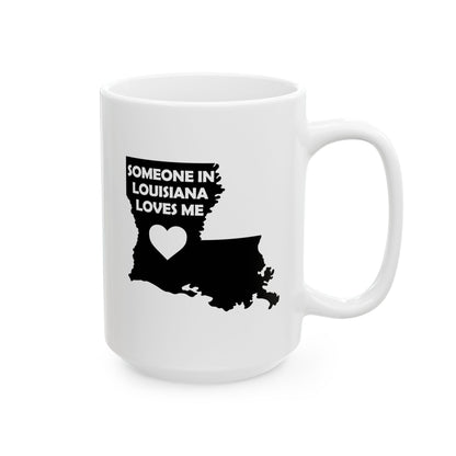 White mug with black silhouette of Louisiana and text 'Someone in Louisiana loves me' on a white background