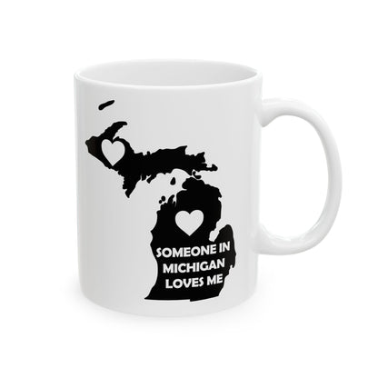 White mug with black map of Michigan and text 'Someone in Michigan loves me' on a white background